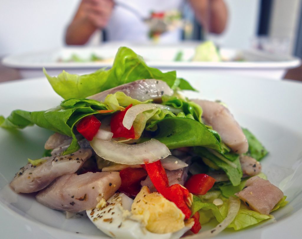 A classic German salad with greens, fish, onions, and hard boiled eggs.