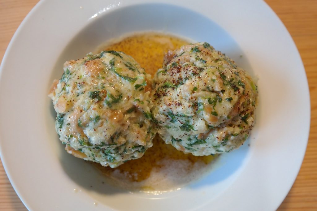 Two spinach dumplings served in a bowl